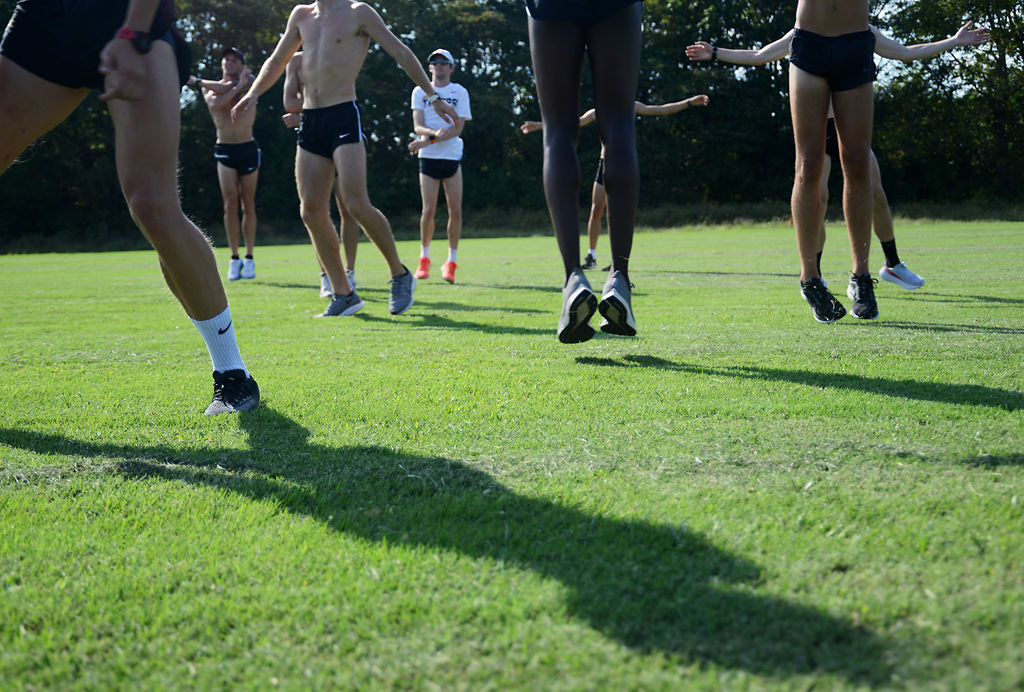 Members from MU's mens cross-country team warm up